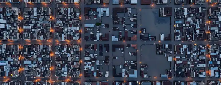 Top-down aerial of a city grid with flooded blocks standing out from dry ones